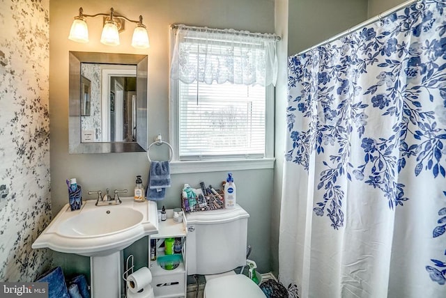 215 Fredericksburg Ave, Louisa, VA 23093 - bathroom with toilet and a shower with shower curtain