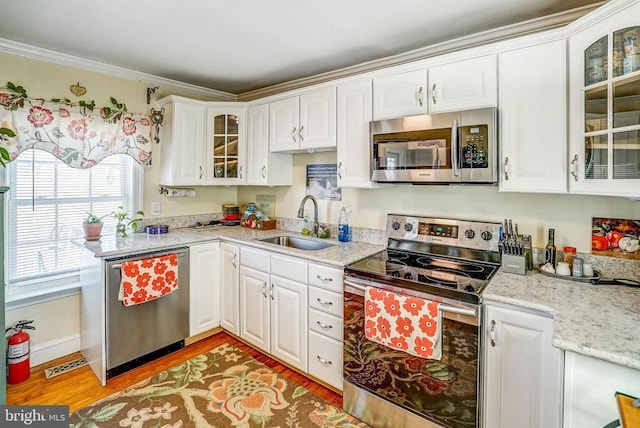 215 Fredericksburg Ave, Louisa, VA 23093 - kitchen featuring white cabinetry, stainless steel appliances, light wood-style flooring, and a sink
