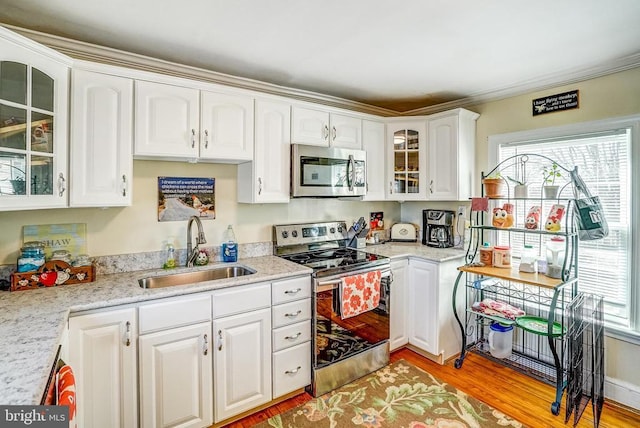 215 Fredericksburg Ave, Louisa, VA 23093 - kitchen featuring plenty of natural light, appliances with stainless steel finishes, a sink, and glass insert cabinets