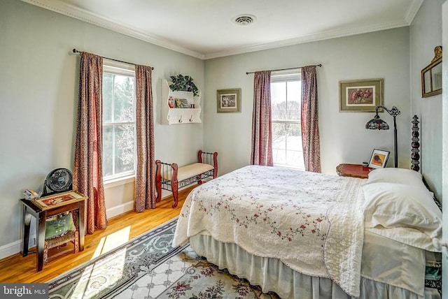 215 Fredericksburg Ave, Louisa, VA 23093 - bedroom featuring multiple windows, visible vents, light wood-style flooring, and ornamental molding