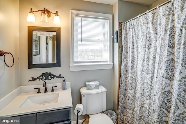 215 Fredericksburg Ave, Louisa, VA 23093 - bathroom with vanity, toilet, and plenty of natural light