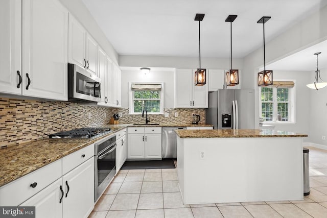 2357 Brighton Pl, Jeffersonton, VA 22724 - kitchen with appliances with stainless steel finishes, a center island, light tile patterned floors, and tasteful backsplash