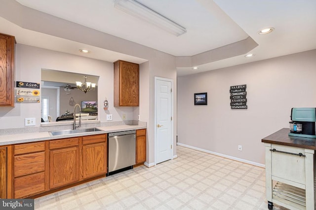 11313 Macon Dr, Fredericksburg, VA 22407 - kitchen with stainless steel dishwasher, brown cabinetry, recessed lighting, light flooring, and a chandelier