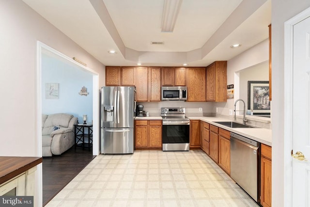 11313 Macon Dr, Fredericksburg, VA 22407 - kitchen with stainless steel appliances, light flooring, recessed lighting, brown cabinetry, and light countertops