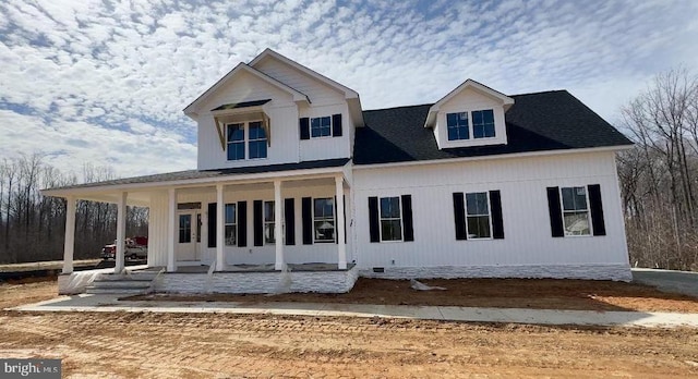 view of front of property with covered porch and a shingled roof