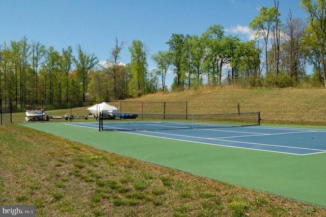 view of sport court with a lawn