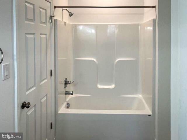 bathroom with tiled shower and vanity