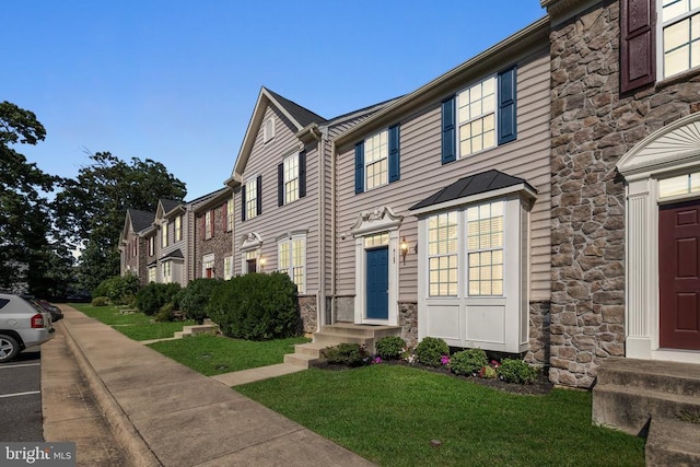 3103 Alliance Ct, Fredericksburg, VA 22408 - view of front of home with stone siding, a standing seam roof, a metal roof, a front yard, and entry steps