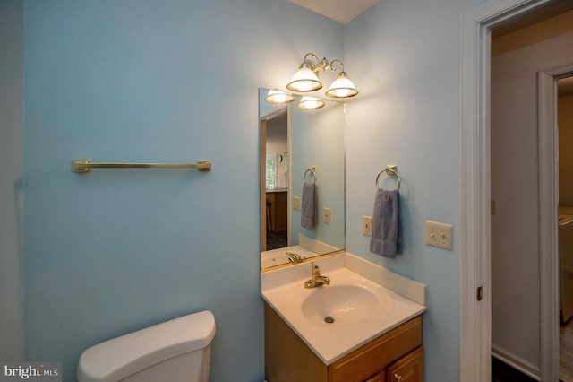 bathroom with toilet and vanity