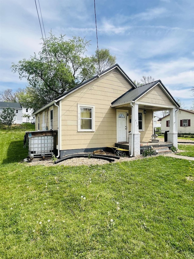 bungalow-style house with covered porch and a front yard
