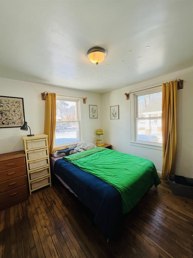 bedroom with dark wood finished floors