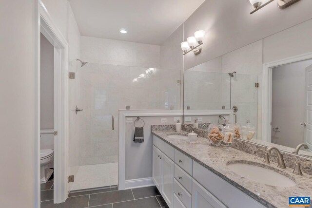 bathroom with toilet, tile patterned flooring, a sink, and a shower stall