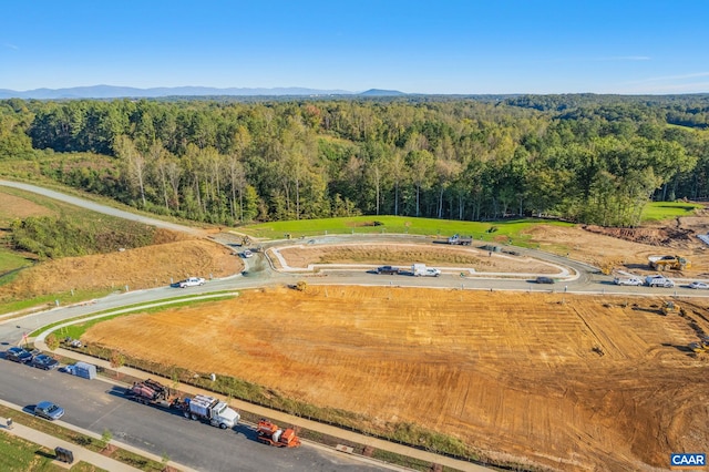 birds eye view of property featuring a view of trees