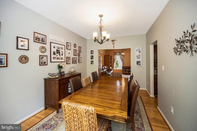 6733 Averett Ct, Fredericksburg, VA 22407 - dining area featuring baseboards, a notable chandelier, and light wood-style flooring