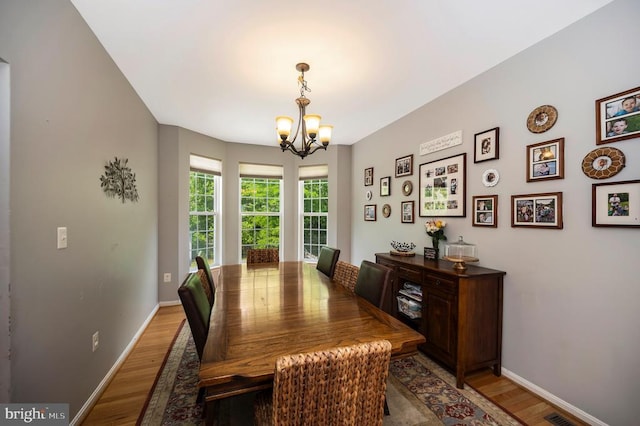 6733 Averett Ct, Fredericksburg, VA 22407 - dining area with baseboards, light wood finished floors, and an inviting chandelier
