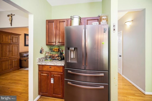 6733 Averett Ct, Fredericksburg, VA 22407 - kitchen featuring light stone countertops, baseboards, stainless steel refrigerator with ice dispenser, and light wood-style floors
