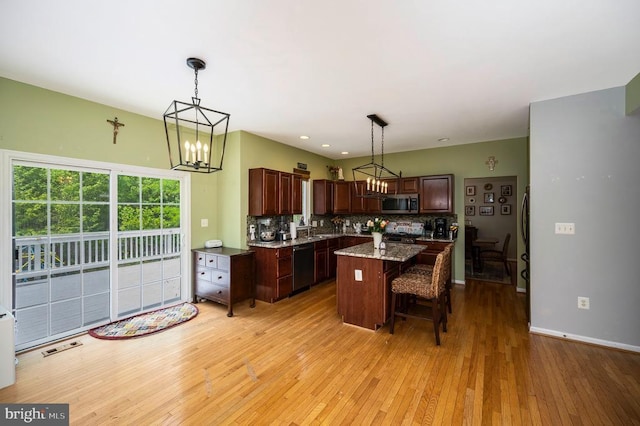 6733 Averett Ct, Fredericksburg, VA 22407 - kitchen with a notable chandelier, range, a center island, stainless steel microwave, and dishwashing machine