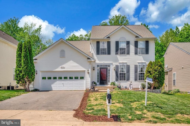 6733 Averett Ct, Fredericksburg, VA 22407 - view of front of property featuring a garage, central air condition unit, a shingled roof, aphalt driveway, and a front lawn