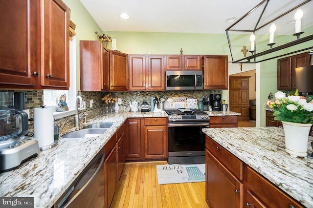 6733 Averett Ct, Fredericksburg, VA 22407 - kitchen with light stone countertops, a sink, stainless steel appliances, tasteful backsplash, and light wood-type flooring