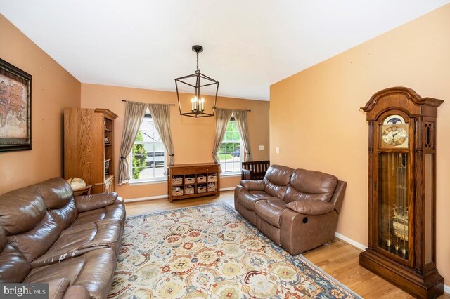 6733 Averett Ct, Fredericksburg, VA 22407 - living room featuring baseboards, a notable chandelier, and light wood finished floors