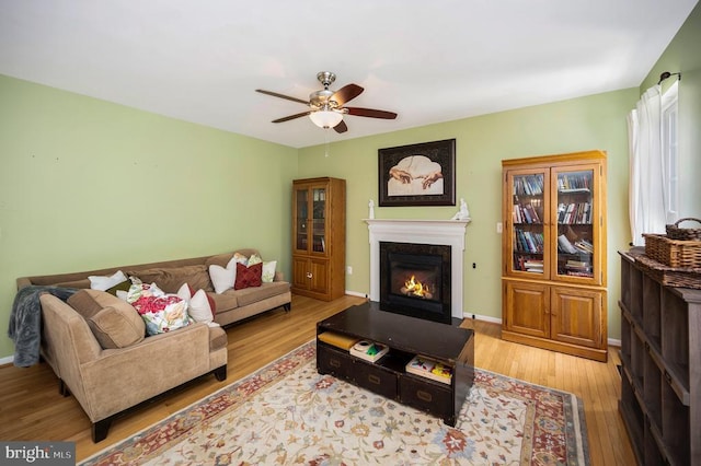6733 Averett Ct, Fredericksburg, VA 22407 - living room featuring a fireplace with flush hearth, baseboards, a ceiling fan, and wood finished floors