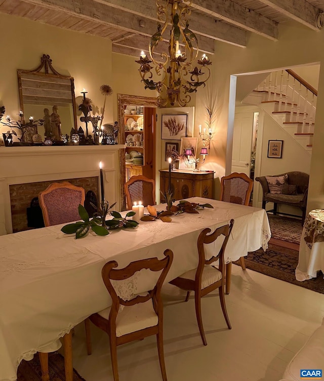dining room with beam ceiling, a notable chandelier, and stairs