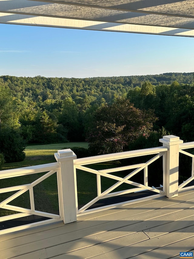 wooden deck with a forest view