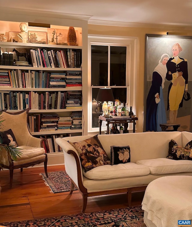 sitting room featuring ornamental molding and hardwood / wood-style flooring