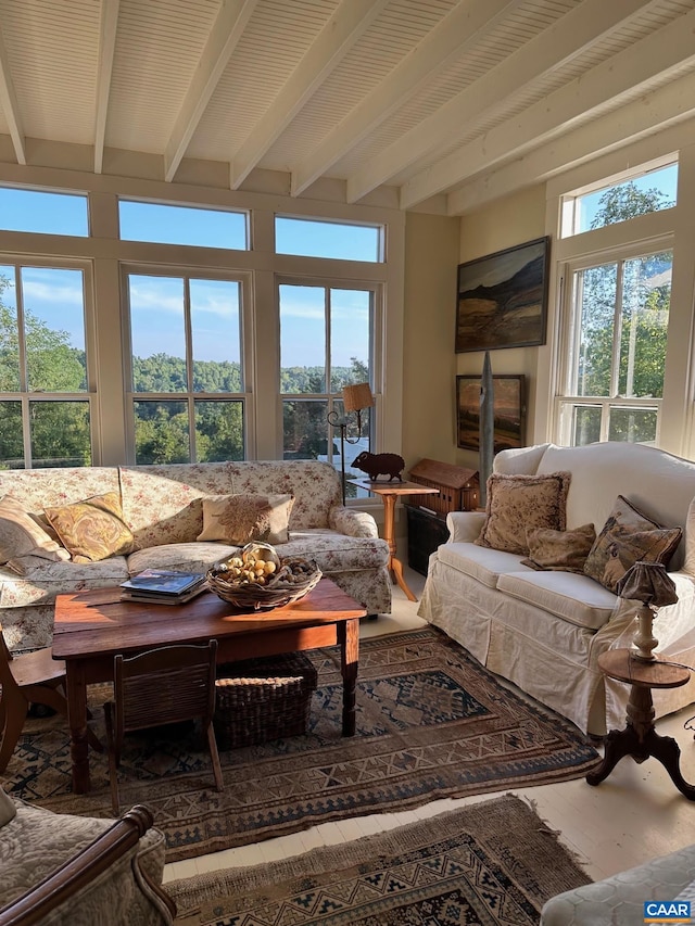 sunroom featuring beamed ceiling and plenty of natural light