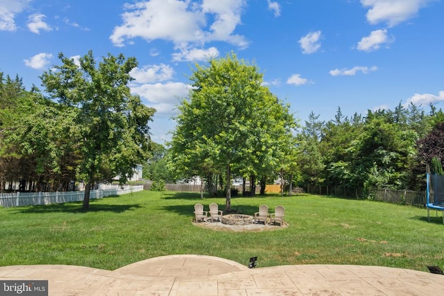 11721 Hoover Ln, Fredericksburg, VA 22407 - fenced yard featuring a trampoline, an outdoor fire pit, and a patio area