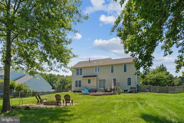 11721 Hoover Ln, Fredericksburg, VA 22407 - back of house with an outdoor fire pit and a fenced backyard