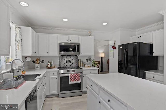 11721 Hoover Ln, Fredericksburg, VA 22407 - kitchen featuring stainless steel appliances, white cabinetry, light countertops, recessed lighting, and light wood-style floors