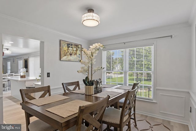 11721 Hoover Ln, Fredericksburg, VA 22407 - dining room with crown molding, light wood-style floors, a wainscoted wall, and a decorative wall