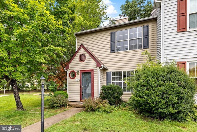 11260 Girven Ct, Fredericksburg, VA 22407 - view of front of house with a front yard and a chimney