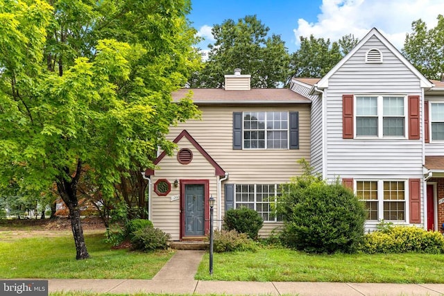 11260 Girven Ct, Fredericksburg, VA 22407 - townhome / multi-family property with a chimney and a front lawn