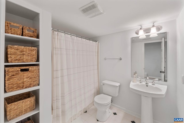bathroom with toilet, baseboards, tile patterned flooring, a sink, and curtained shower