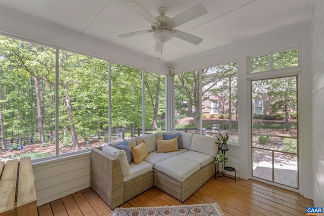 sunroom featuring a ceiling fan and an outdoor hangout area