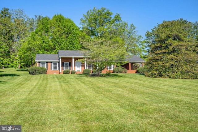 view of front of house with brick siding and a front yard