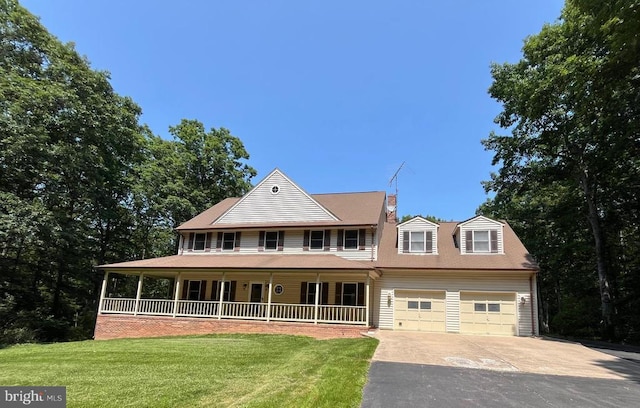 - view of front of property with a porch, driveway, a front lawn, and a garage