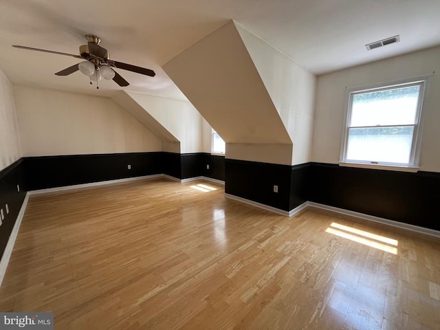  - bonus room featuring plenty of natural light, light wood-type flooring, a ceiling fan, and baseboards