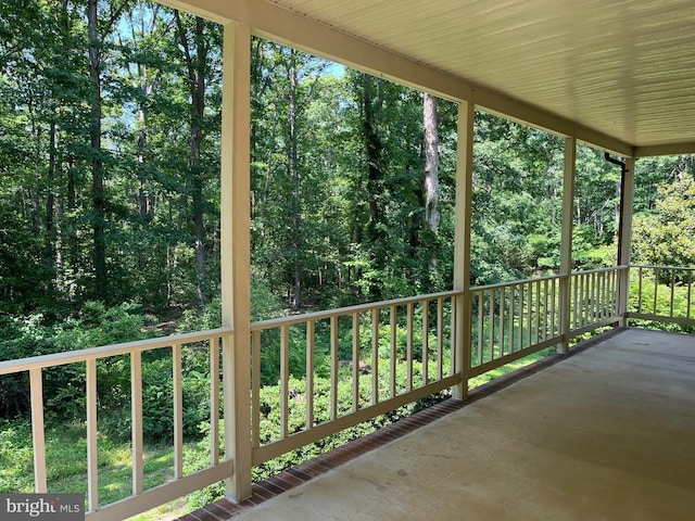  - view of patio / terrace with a wooded view