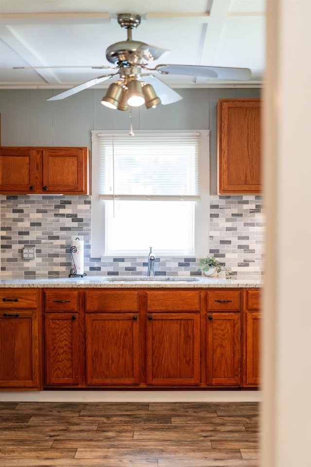 143 Pkin Ln, Raphine, VA 24472 - kitchen featuring wood finished floors, a ceiling fan, decorative backsplash, brown cabinets, and beam ceiling
