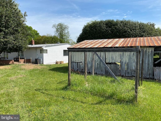  - view of pole building featuring a yard and central AC
