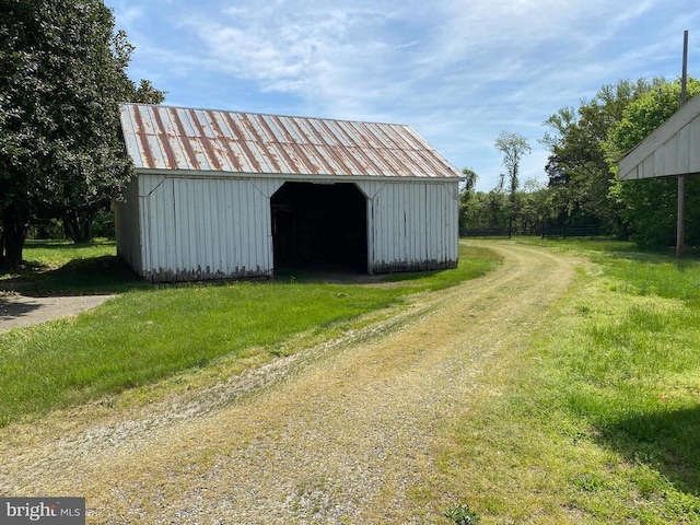  - view of pole building featuring a lawn