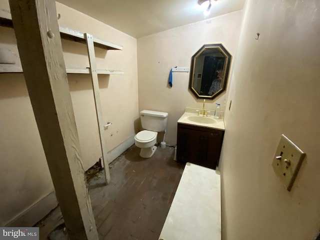  - bathroom with toilet, wood finished floors, and vanity