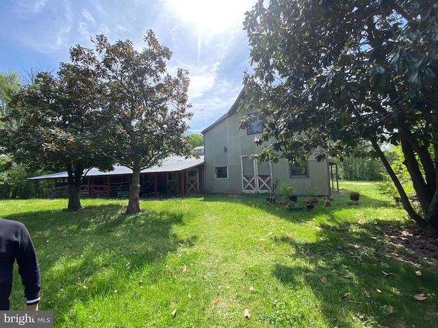  - view of grassy yard with a barn and an outdoor structure