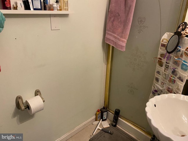  - bathroom with baseboards and an enclosed shower
