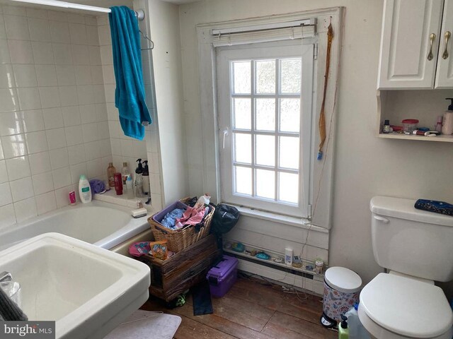  - full bathroom featuring healthy amount of natural light, toilet, a sink, and wood finished floors