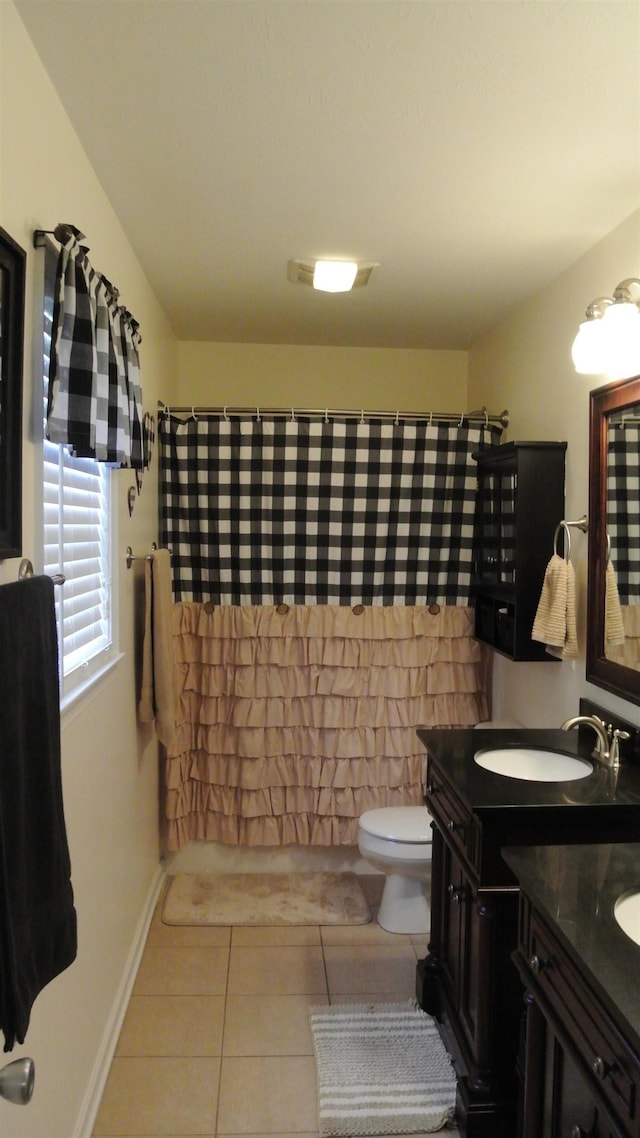 full bathroom featuring double vanity, toilet, a sink, a shower with curtain, and tile patterned floors