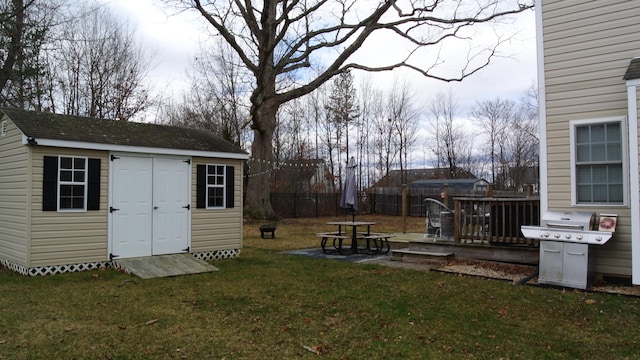 view of yard with a storage unit, an outdoor structure, and fence